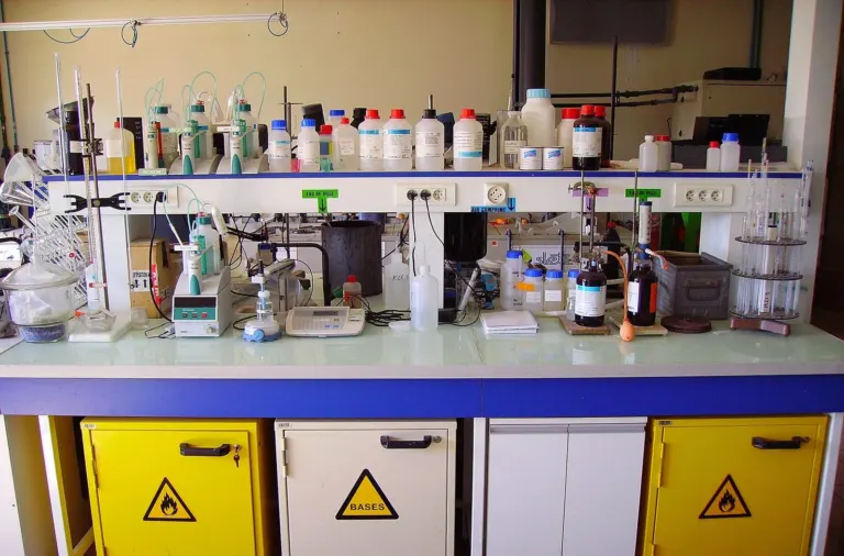 Chemistry laboratory bench with reagent bottles and glassware