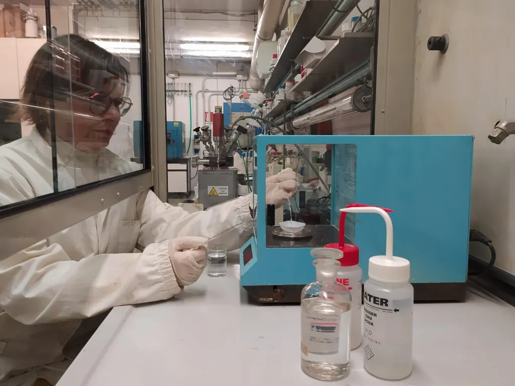 Scientist working at a laboratory fume hood