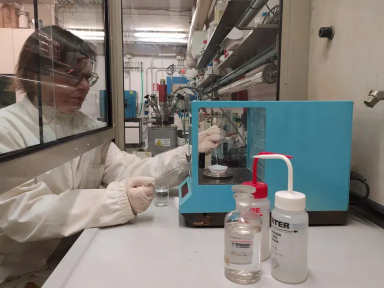 Scientist working at a laboratory fume hood