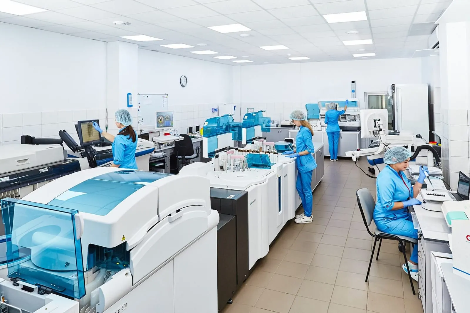 Scientists working at instruments in a modern laboratory