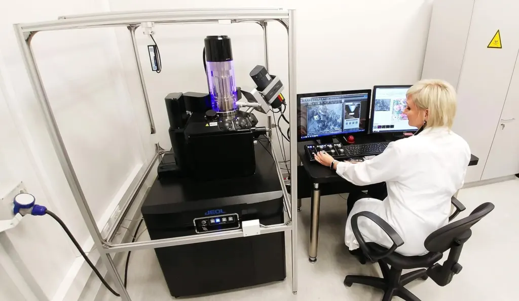 Scientist examining electron microscope images on a monitor