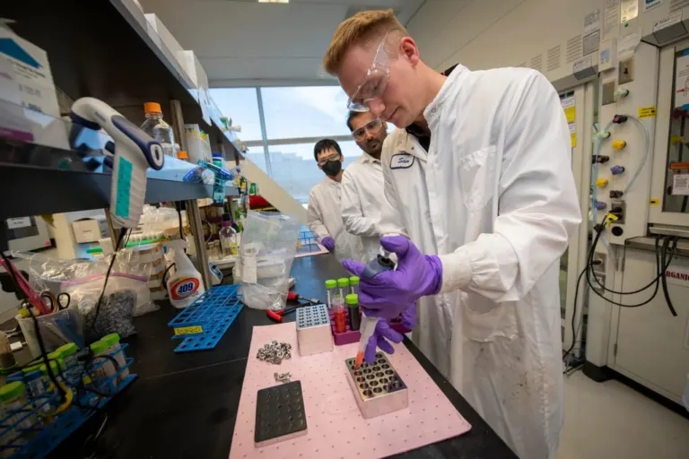 Researchers preparing samples at a laboratory bench