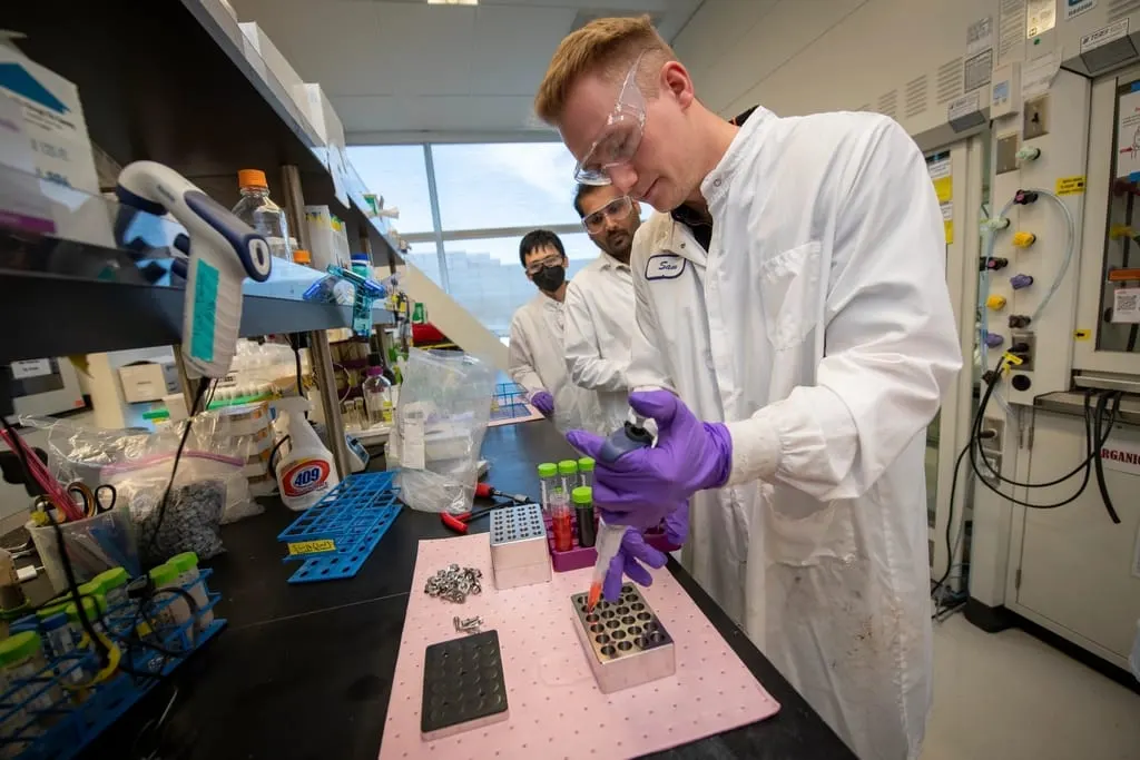 Researchers preparing samples at a laboratory bench
