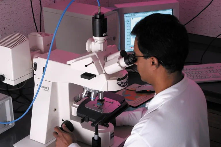 Scientist analysing a sample using laboratory instrumentation
